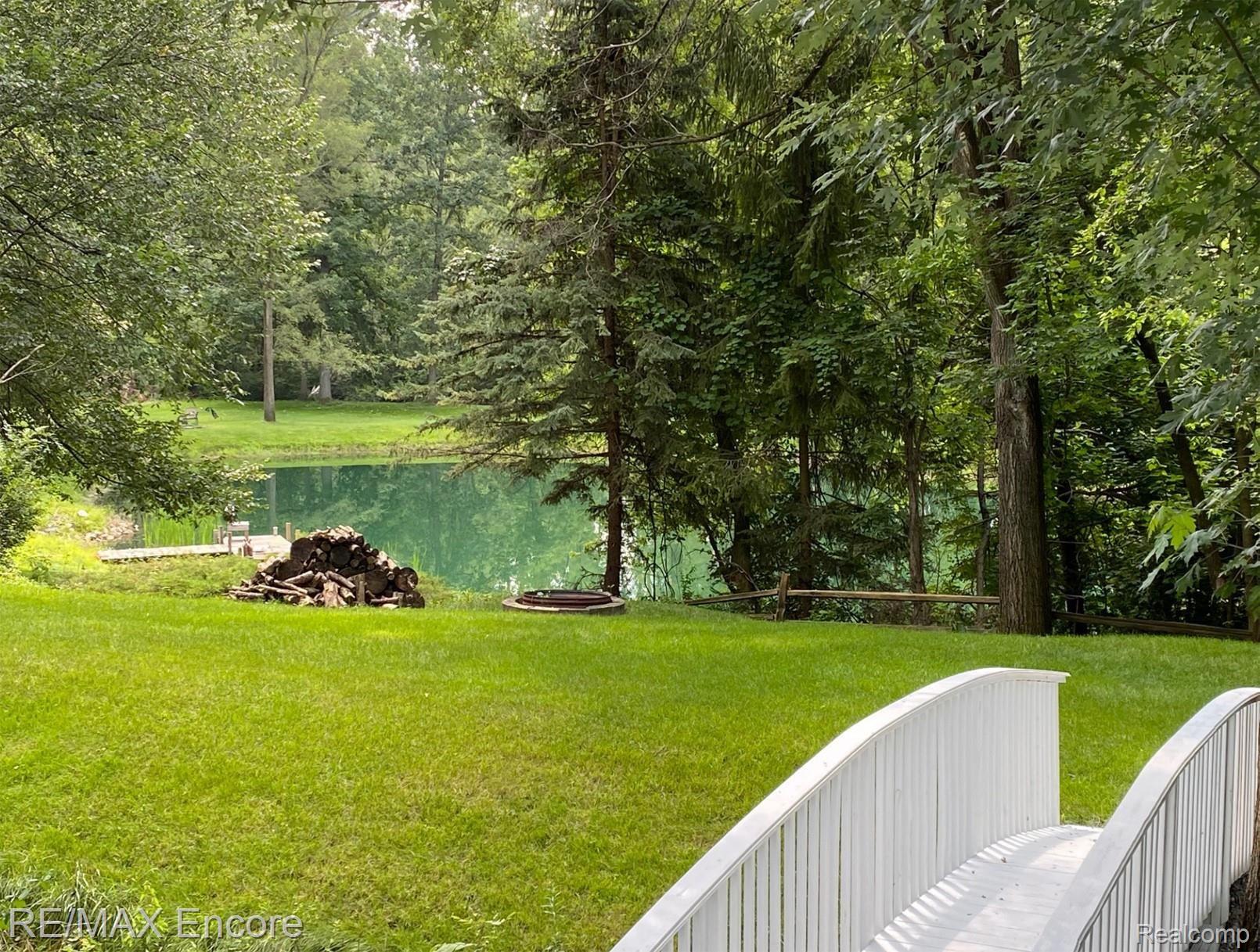 4210 Orion Road Rochester, MI 48306 - Photo 6 of 27 A pretty view of the neighbors pond from the fire ring on Fun Island