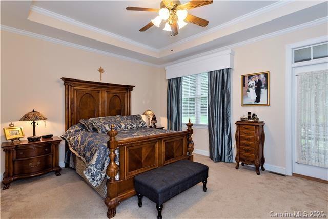 294 Chisholm Trail Rutherfordton, NC 28139 - Photo 17 of 31 a bedroom with a bed and a chandelier
