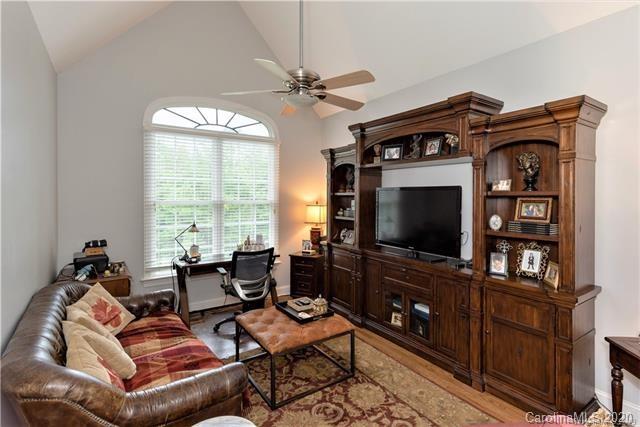 294 Chisholm Trail Rutherfordton, NC 28139 - Photo 21 of 31 a living room with furniture a flat screen tv and a floor to ceiling window
