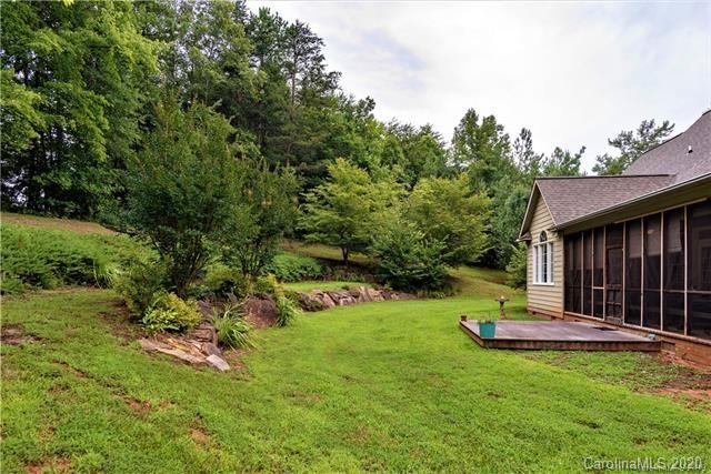 294 Chisholm Trail Rutherfordton, NC 28139 - Photo 28 of 31 a view of a backyard with brick wall and a fountain