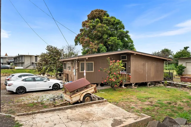 a view of a backyard with parked cars