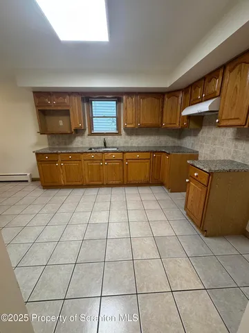 a kitchen with stainless steel appliances granite countertop a sink and cabinets