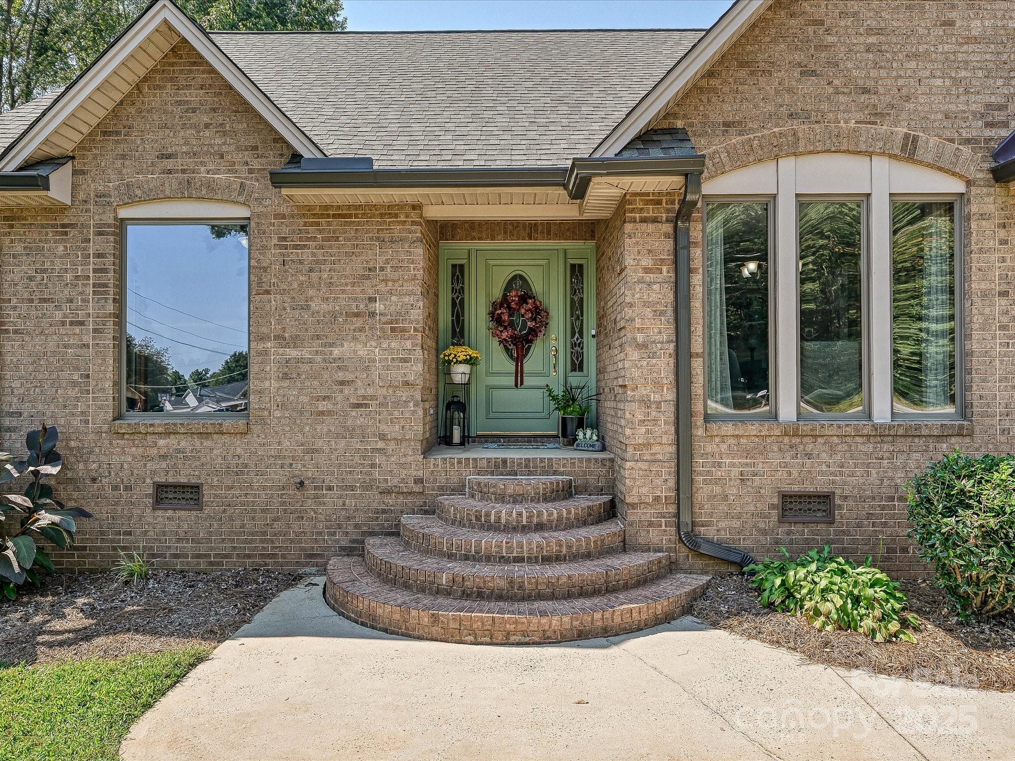7146 Sifford Road Stanley, NC 28164 - Photo 1 of 42 a front view of a house with garden