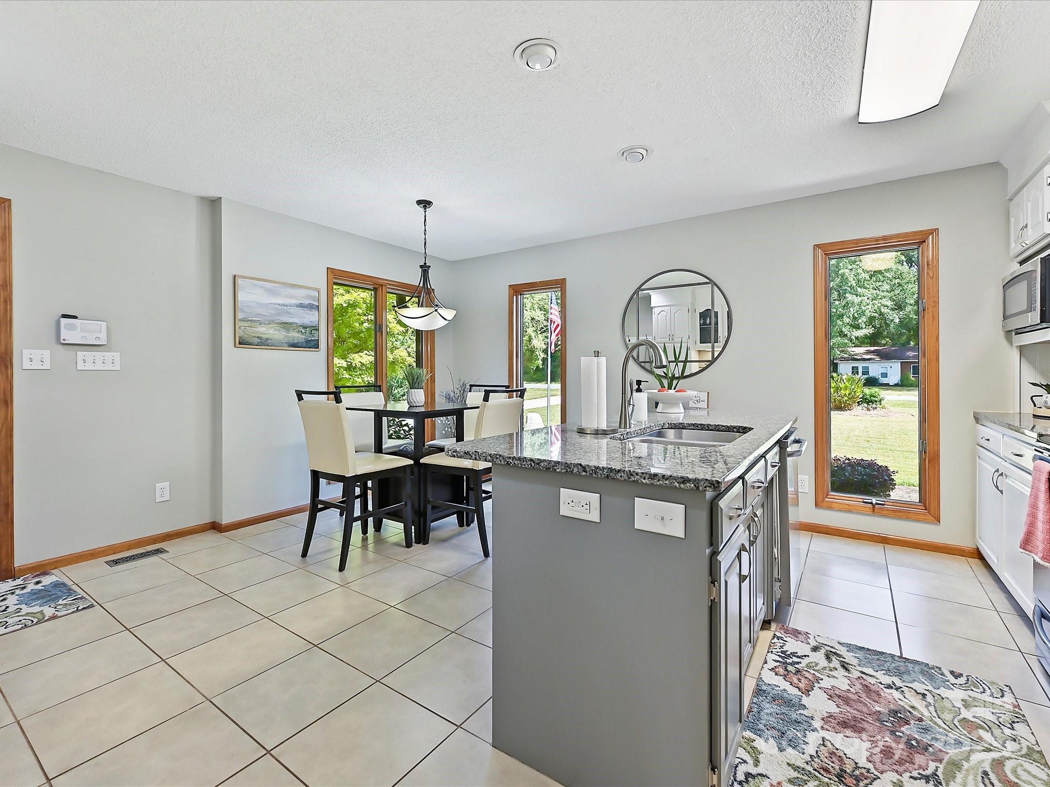 7146 Sifford Road Stanley, NC 28164 - Photo 11 of 42 a view of a dining room with furniture window and wooden floor