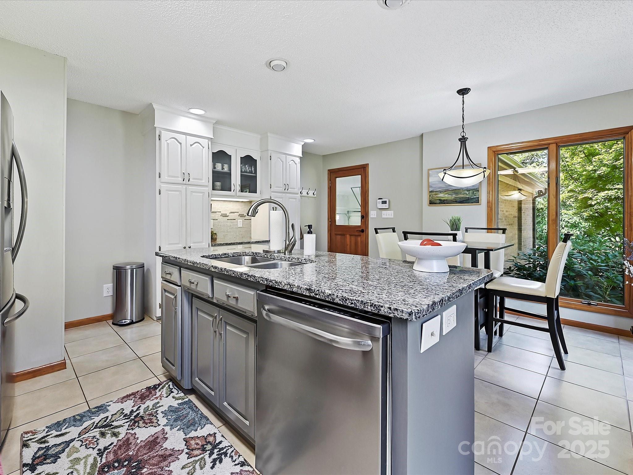 7146 Sifford Road Stanley, NC 28164 - Photo 14 of 42 a kitchen with granite countertop sink stove and cabinets