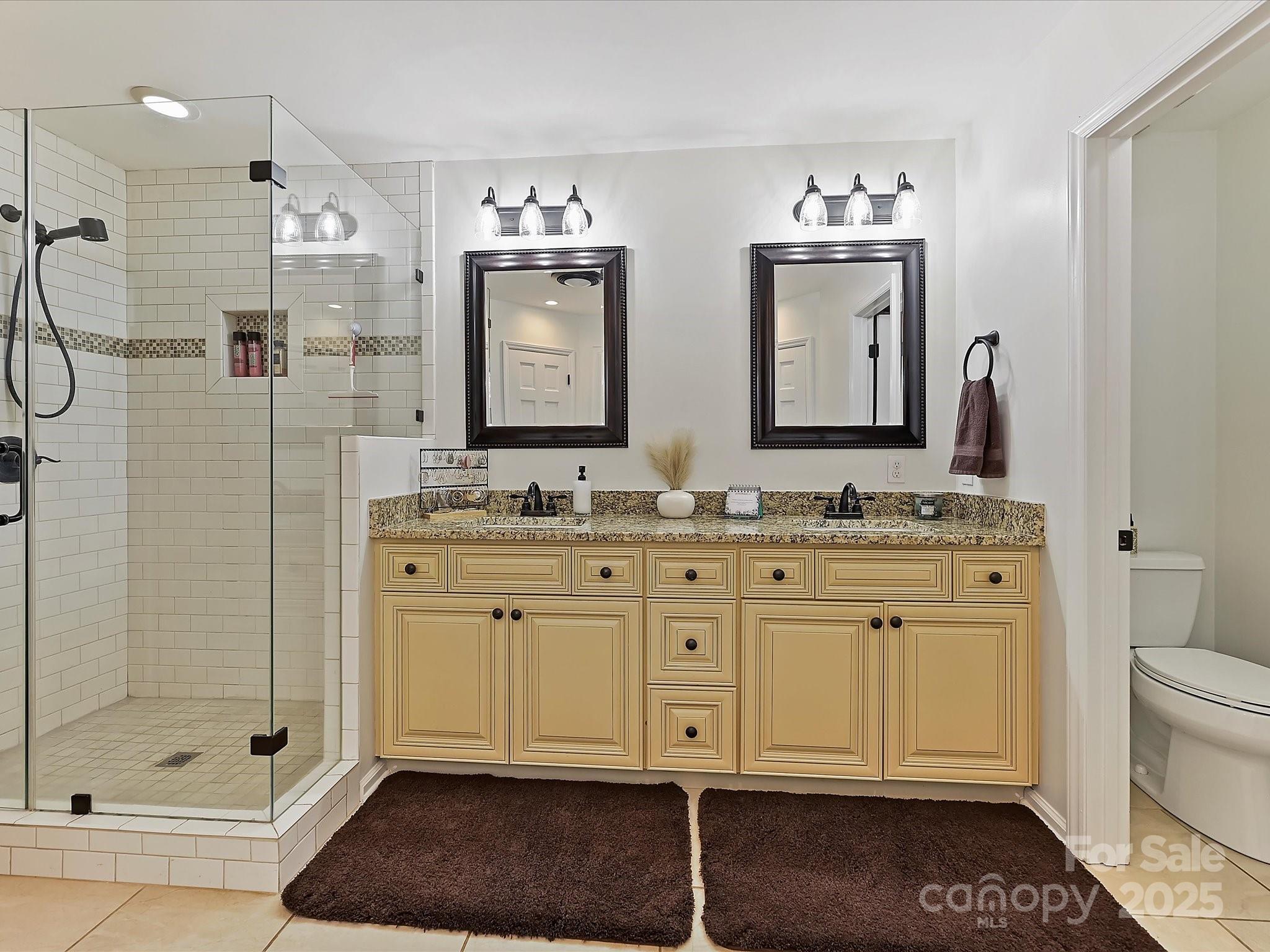 7146 Sifford Road Stanley, NC 28164 - Photo 18 of 42 a bathroom with a double vanity sink a mirror and a shower