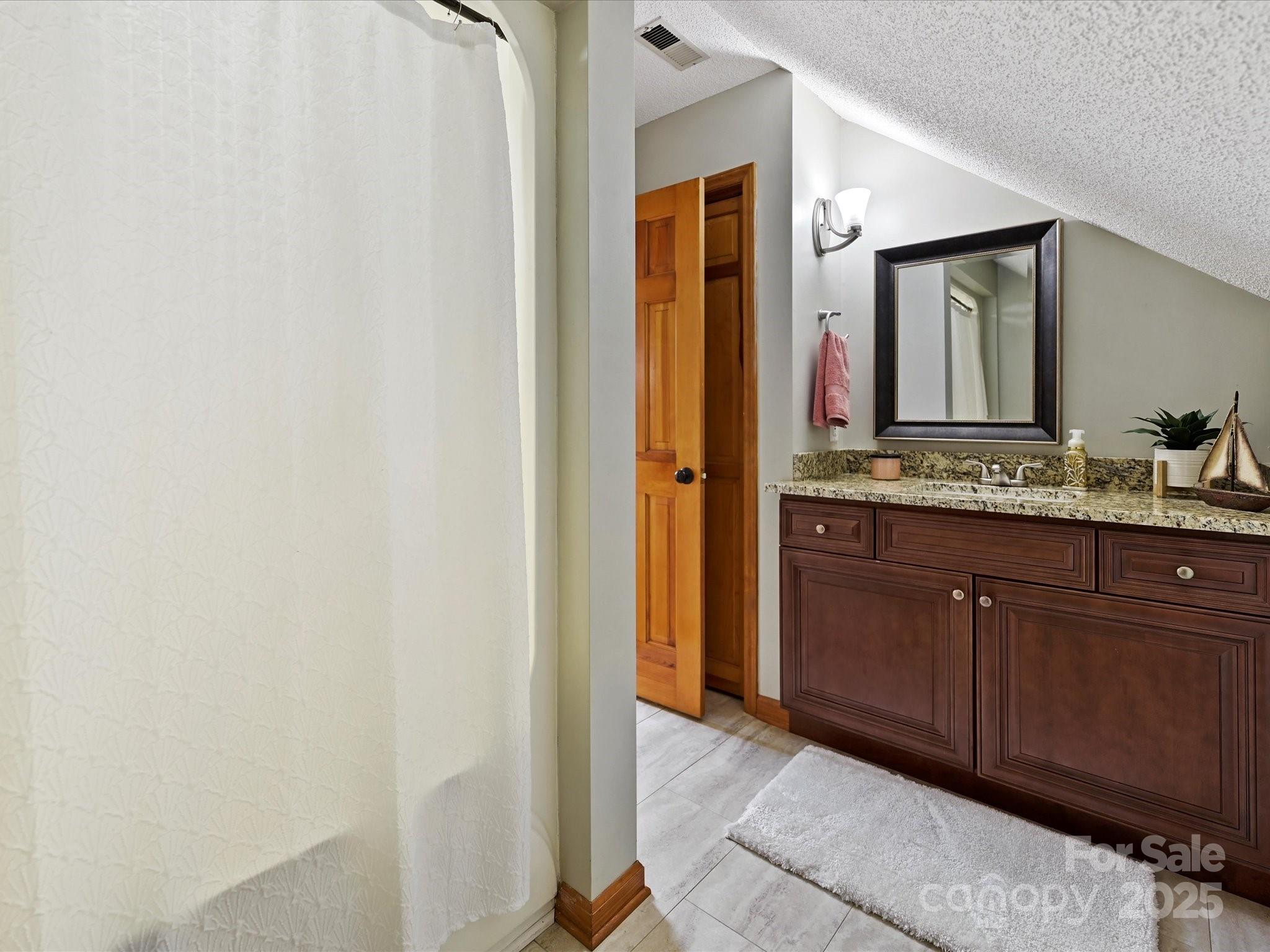 7146 Sifford Road Stanley, NC 28164 - Photo 28 of 42 a bathroom with a granite countertop sink and a mirror