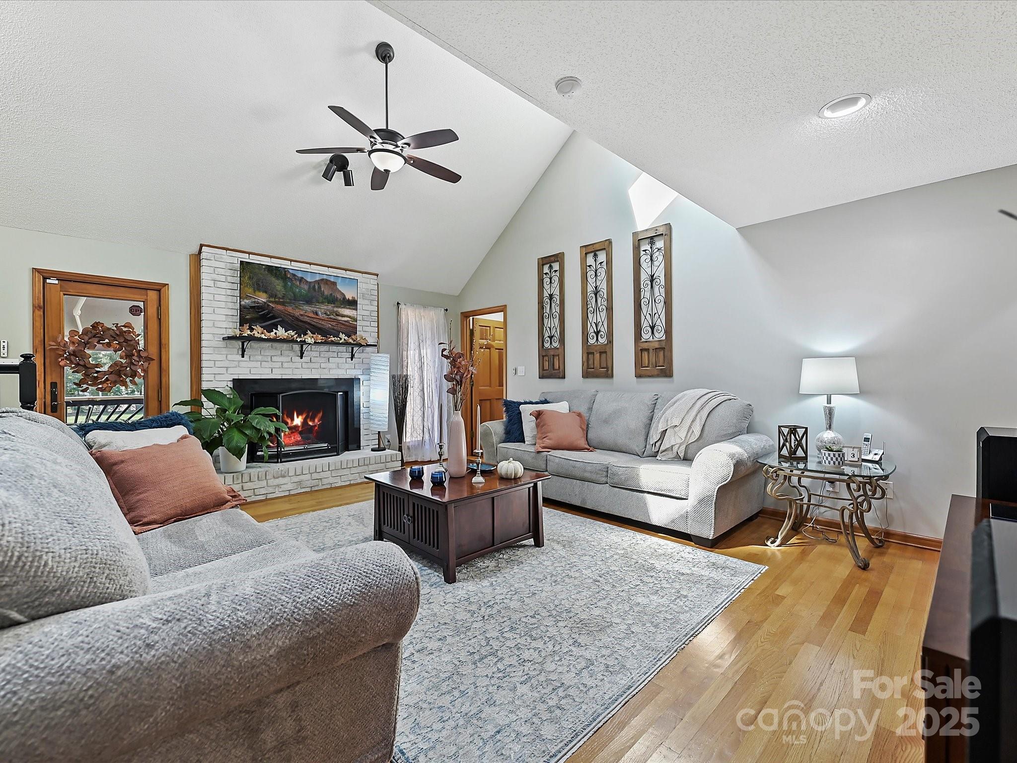 7146 Sifford Road Stanley, NC 28164 - Photo 5 of 42 a living room with furniture a fireplace and a large window