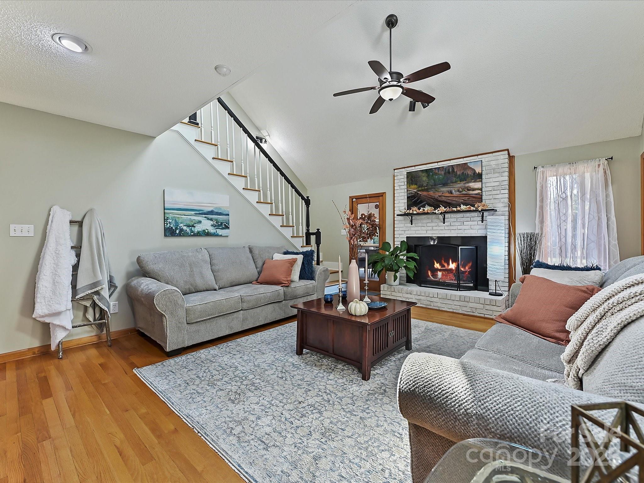 7146 Sifford Road Stanley, NC 28164 - Photo 8 of 42 a living room with furniture a fireplace and a flat screen tv