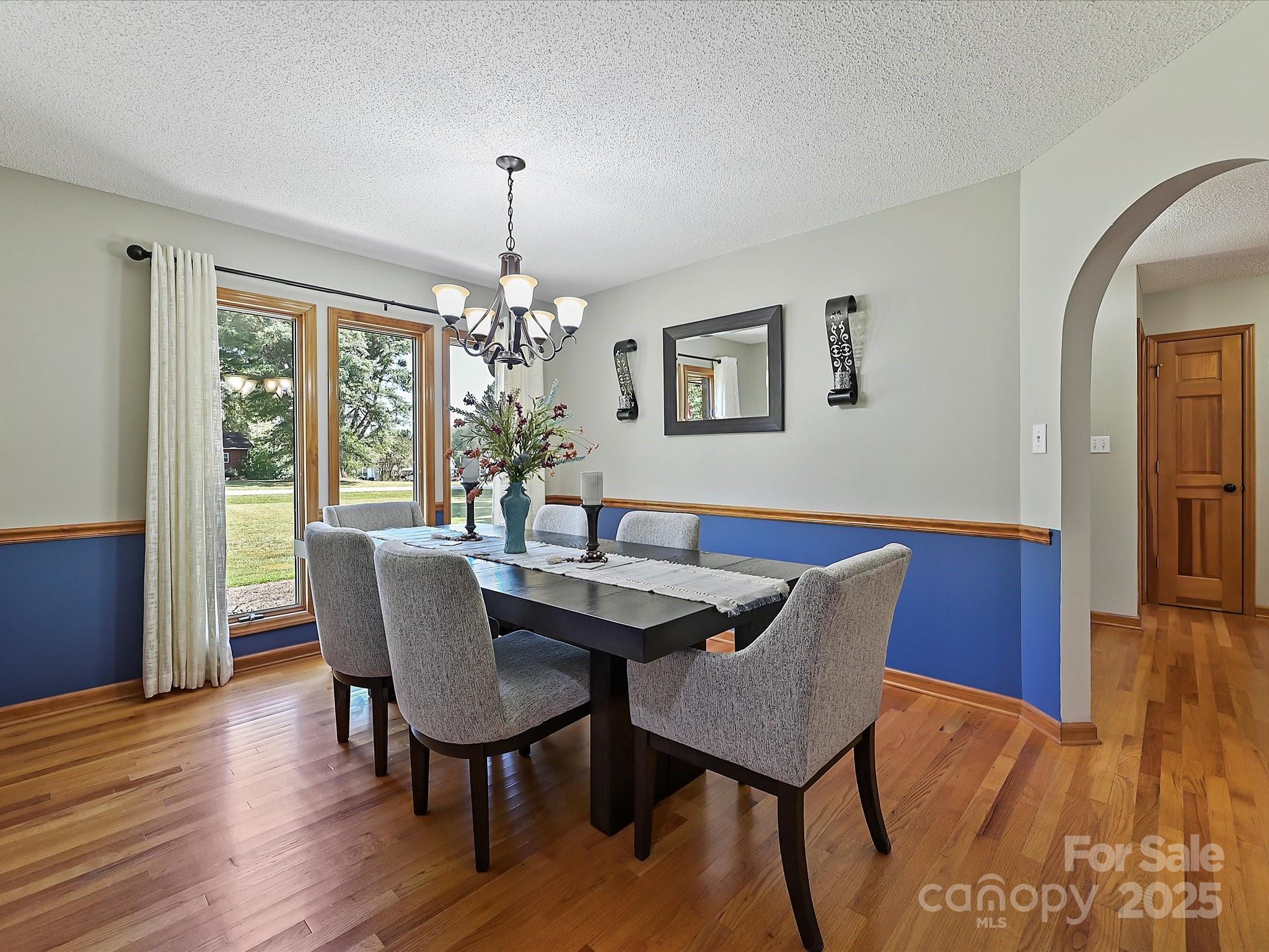 7146 Sifford Road Stanley, NC 28164 - Photo 9 of 42 a dining room with furniture a chandelier and wooden floor