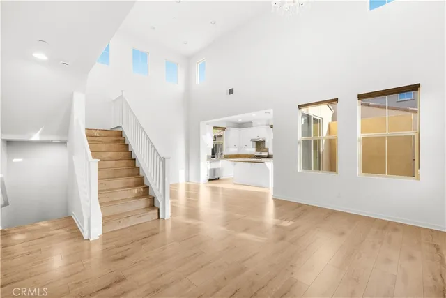 a view of an entryway with wooden floor and a kitchen
