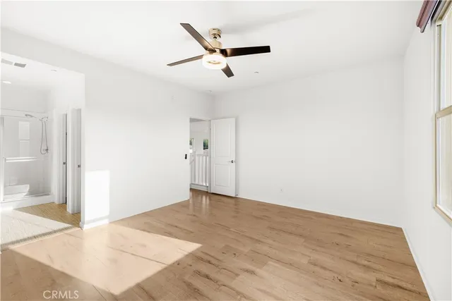 a view of a livingroom with a ceiling fan and wooden floor