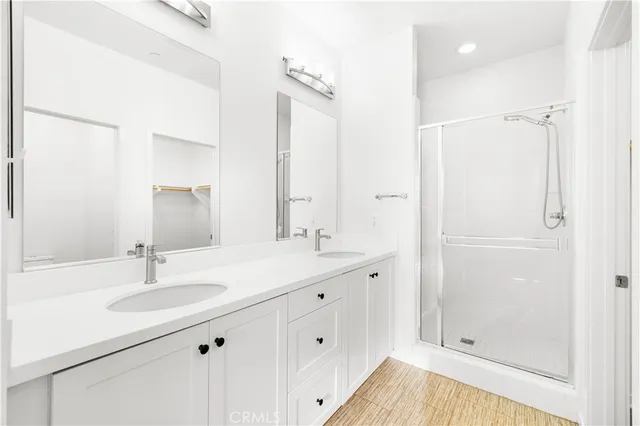 a bathroom with a sink double vanity granite tub and shower