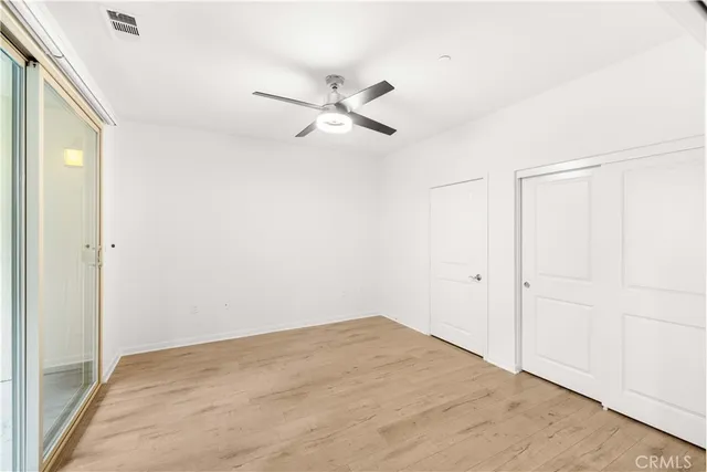 a view of empty room with ceiling fan