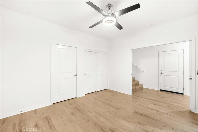 a view of an empty room and wooden floor