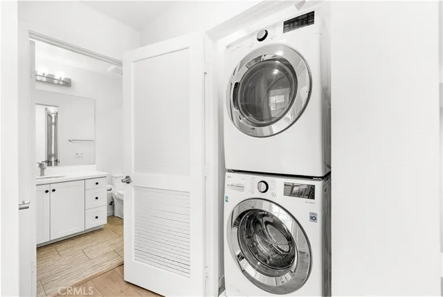a utility room with sink dryer and washer