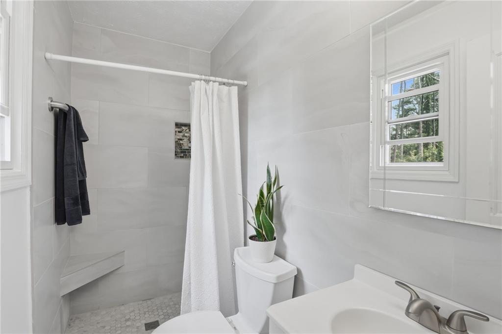 338 Arbour Way Suwanee, GA 30024 - Photo 12 of 32 a white toilet sitting next to a bathroom sink
