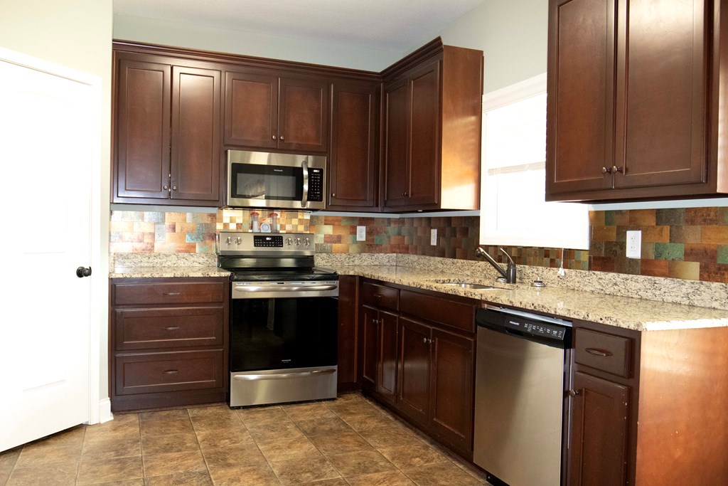 147 McLendon Road Fort Mitchell, AL 36856 - Photo 7 of 17 a kitchen with sink cabinets and stainless steel appliances