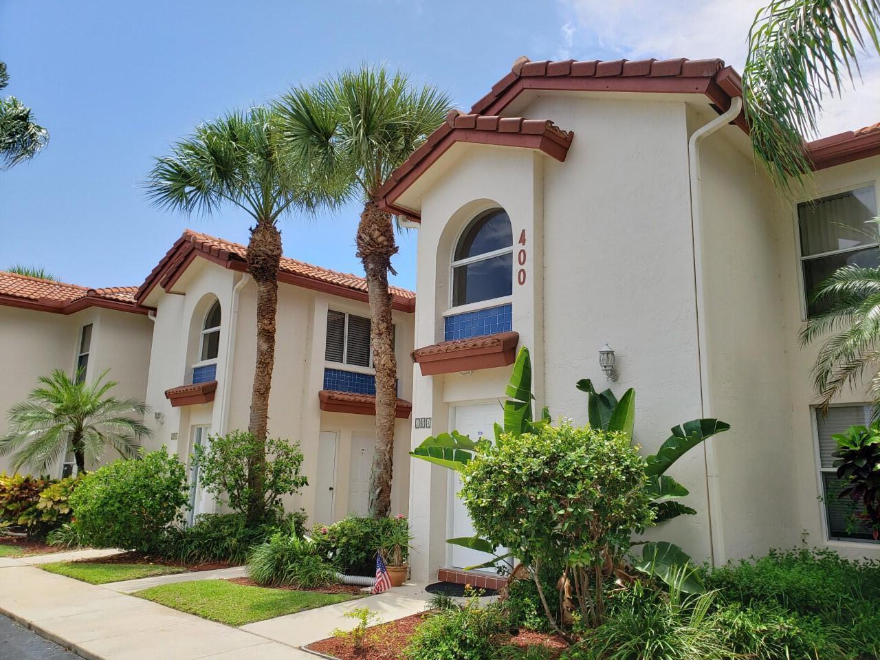 400 Northwest 67th Street, Unit 207 Boca Raton, FL 33487 - Photo 3 of 46 a front view of a house with a yard