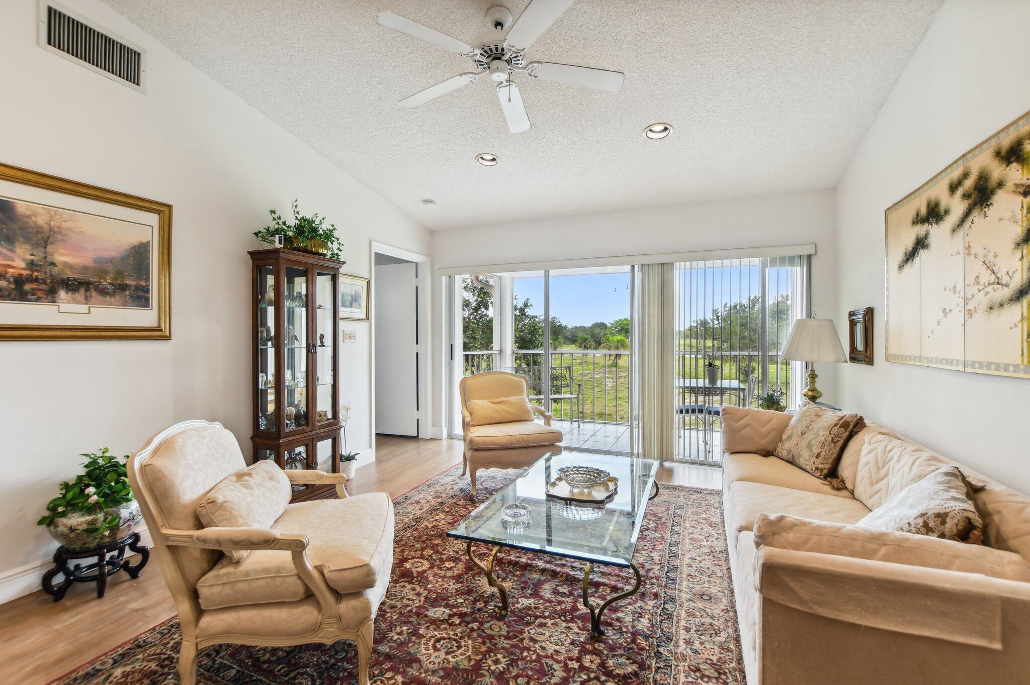 400 Northwest 67th Street, Unit 207 Boca Raton, FL 33487 - Photo 9 of 46 a living room with furniture and a large window