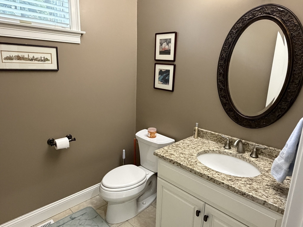 4 Tamarack Lane Sandwich, MA 02563 - Photo 22 of 42 a bathroom with a granite countertop toilet a sink and a mirror