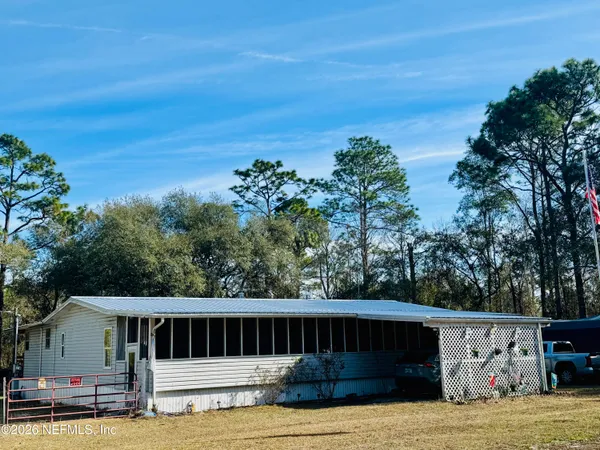 a view of house with backyard and entertaining space