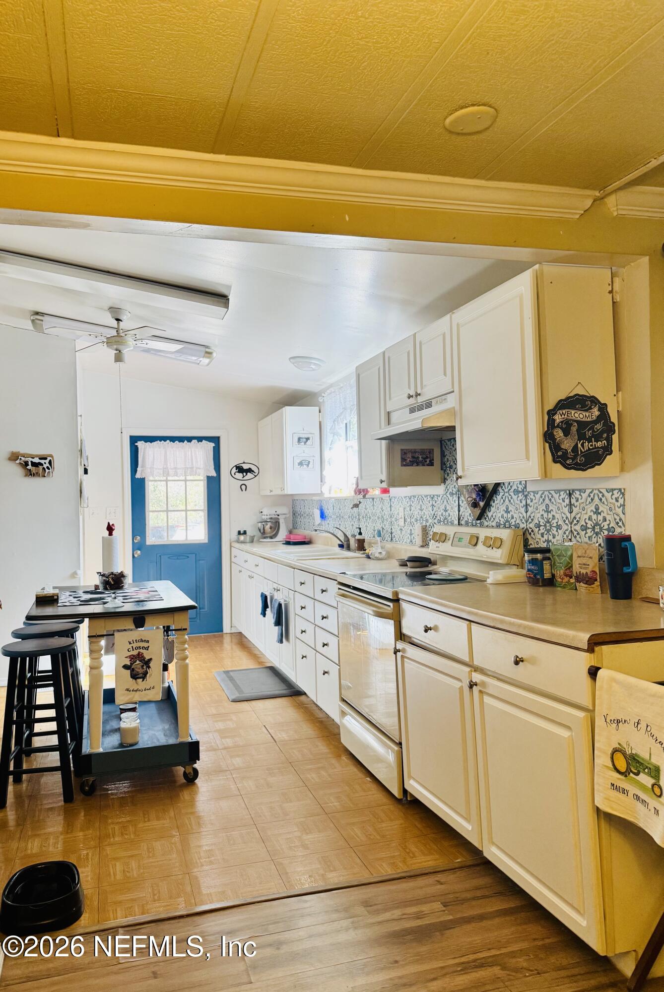 4700 Berry Court Keystone Heights, FL 32656 - Photo 13 of 65 a large white kitchen with a sink and cabinets