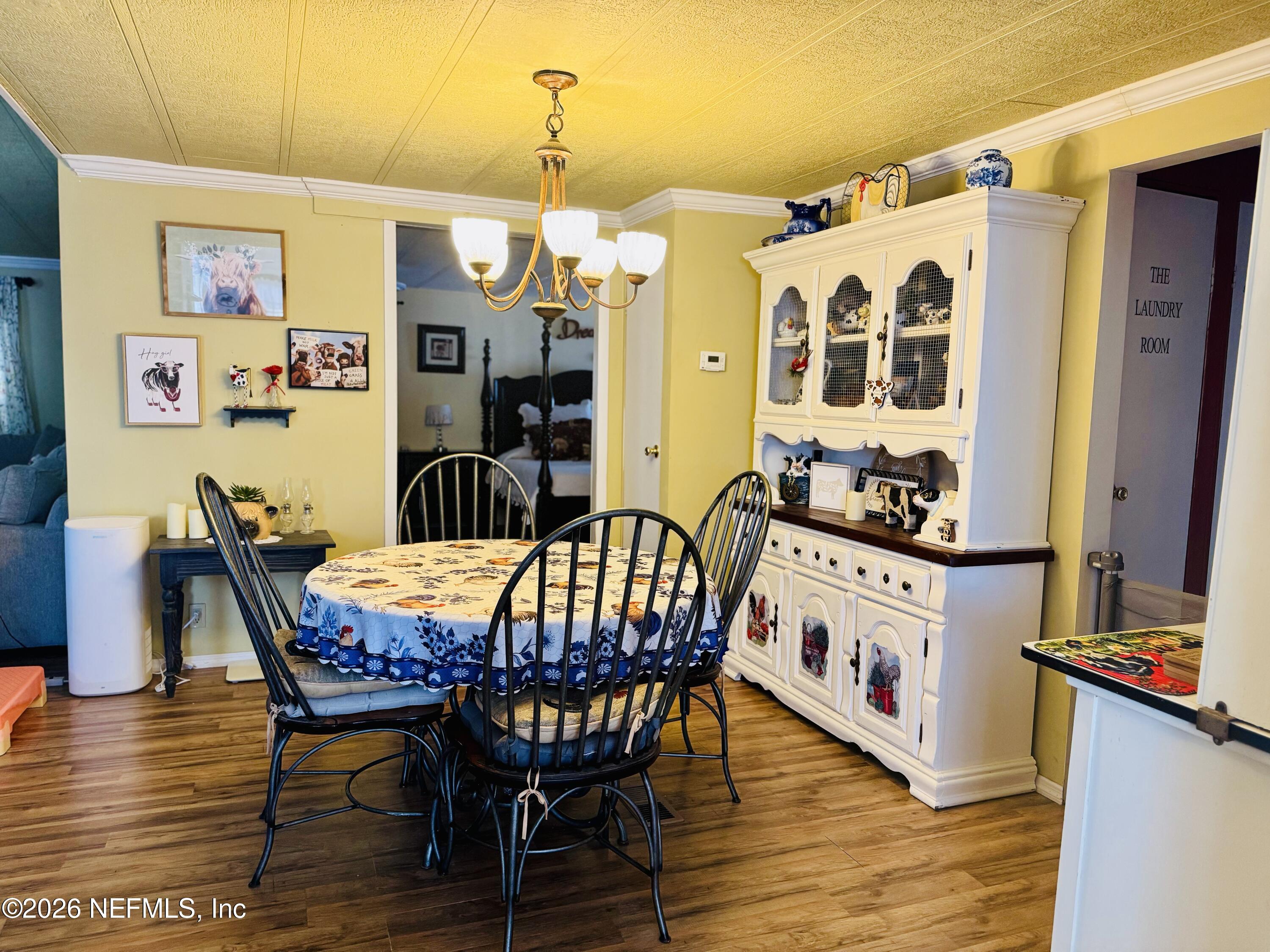 4700 Berry Court Keystone Heights, FL 32656 - Photo 18 of 65 a view of a dining room with furniture and wooden floor