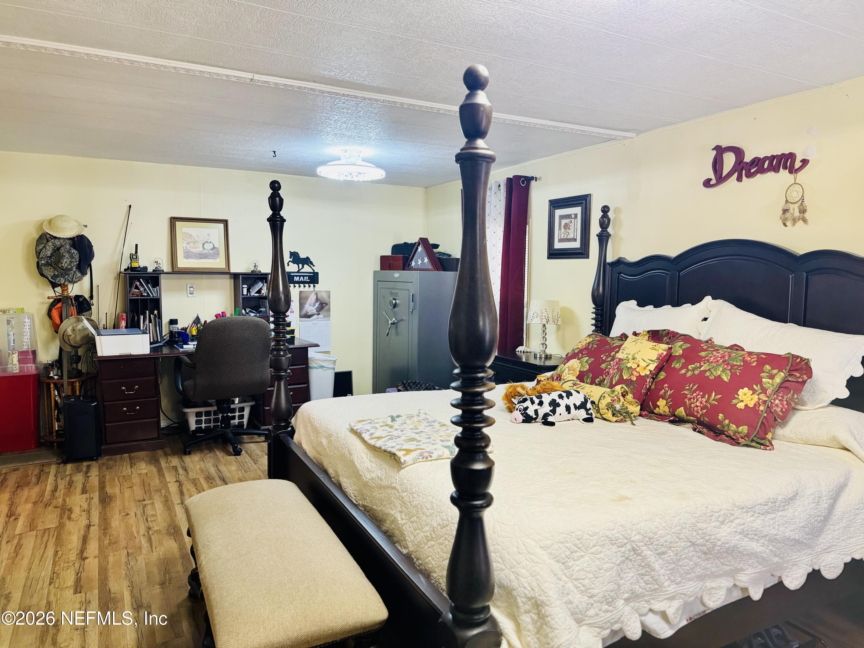 4700 Berry Court Keystone Heights, FL 32656 - Photo 21 of 65 a bedroom with a bed and a table