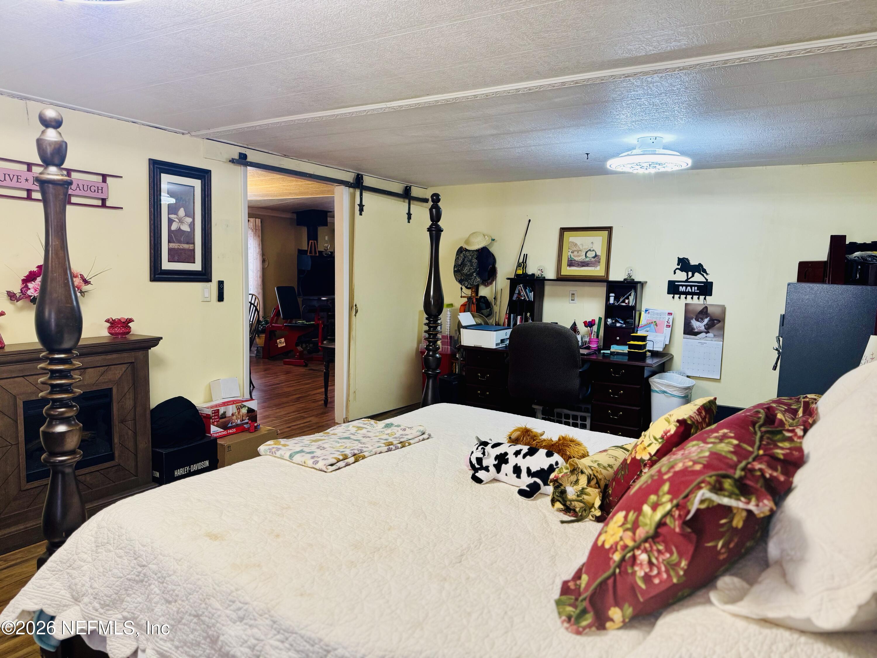 4700 Berry Court Keystone Heights, FL 32656 - Photo 22 of 65 a bed room with a bed and a tv