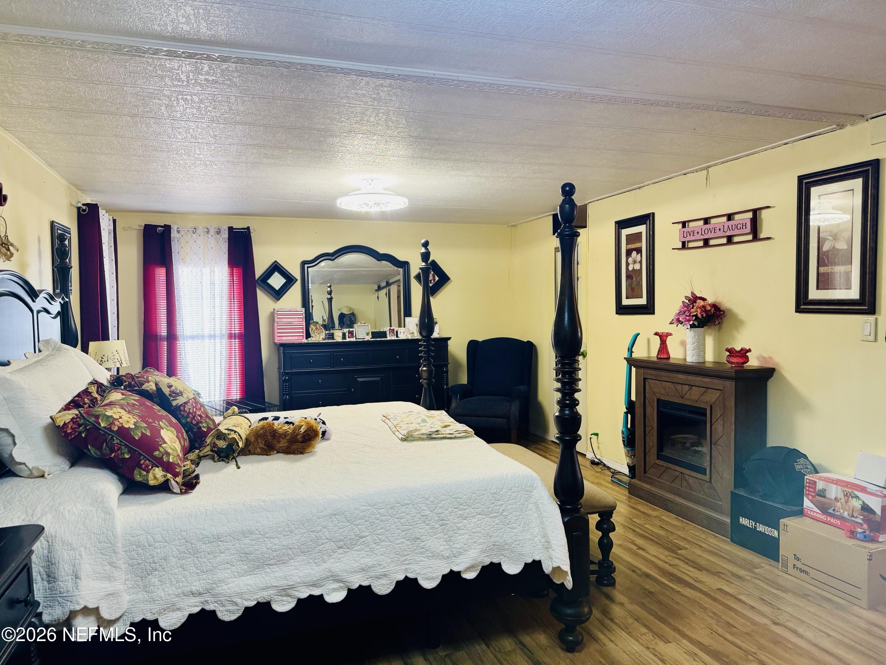 4700 Berry Court Keystone Heights, FL 32656 - Photo 23 of 65 a bedroom with a bed and dresser