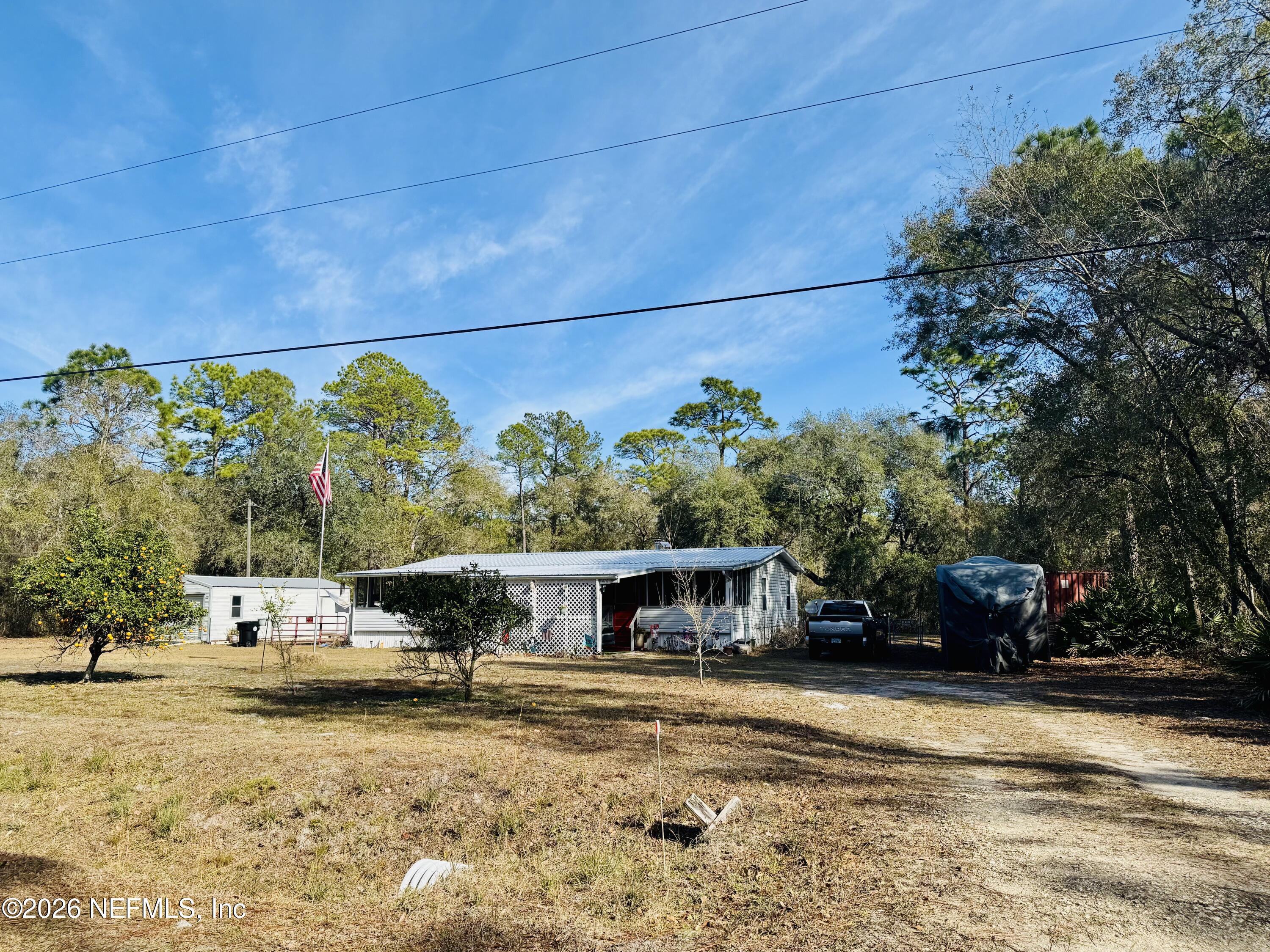 4700 Berry Court Keystone Heights, FL 32656 - Photo 4 of 65 a view of a swimming pool with an outdoor seating