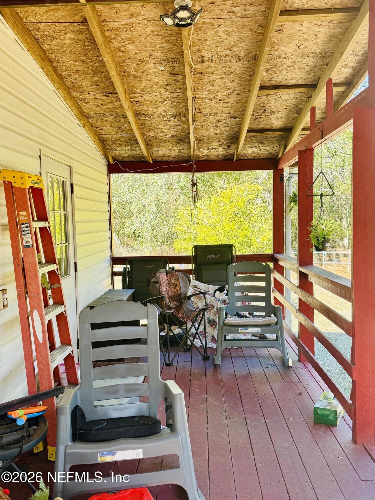 4700 Berry Court Keystone Heights, FL 32656 - Photo 46 of 65 a view of a patio with a table and chairs