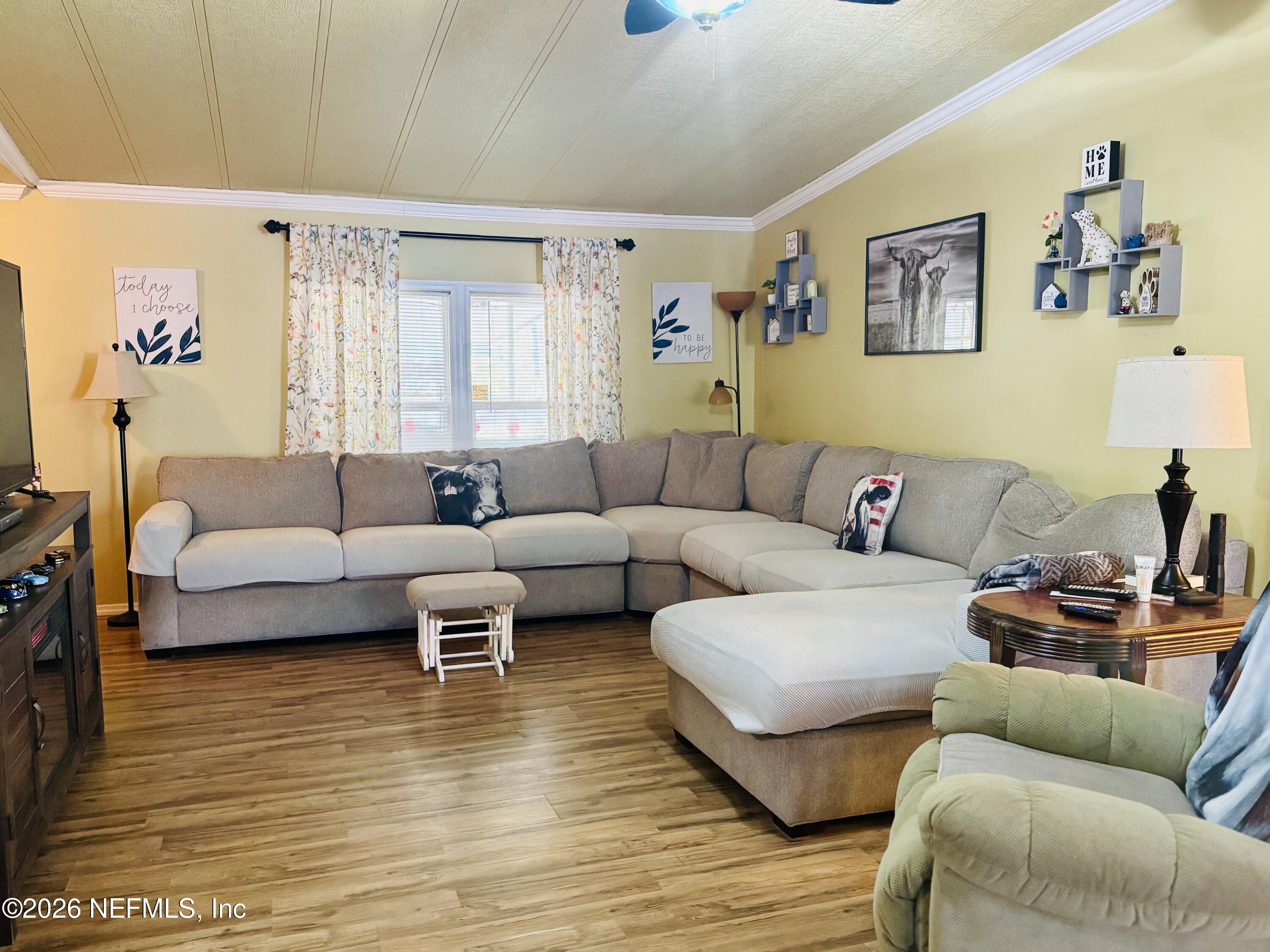 4700 Berry Court Keystone Heights, FL 32656 - Photo 6 of 65 a living room with furniture and a wooden floor