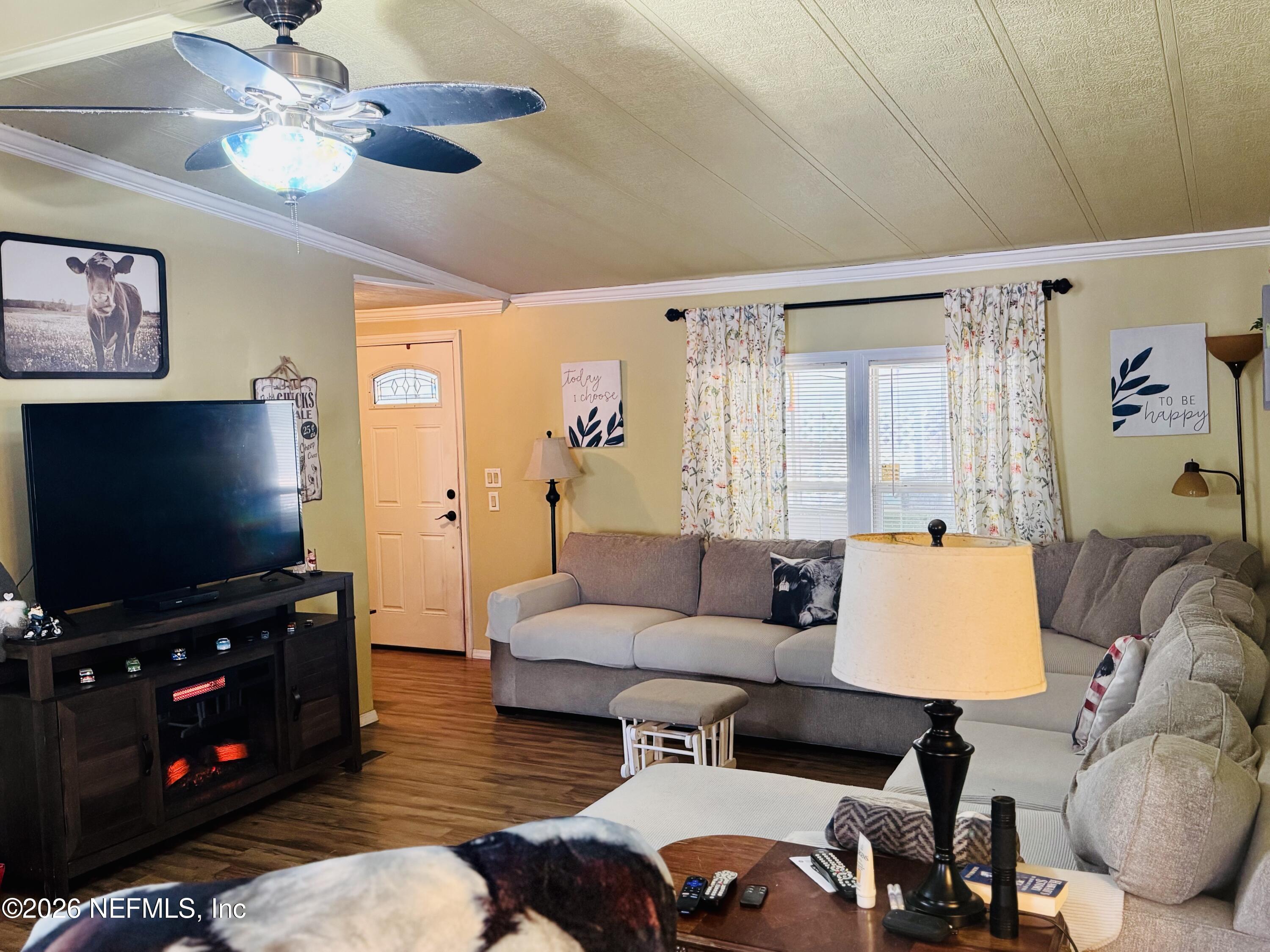 4700 Berry Court Keystone Heights, FL 32656 - Photo 7 of 65 a living room with furniture and a flat screen tv