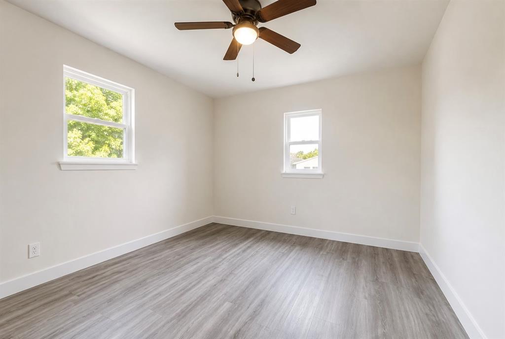 7061 Base Street Azle, TX 76020 - Photo 9 of 13 Wood-finish flooring, white walls, and a ceiling fan with integrated lighting