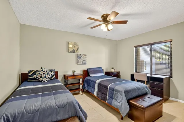 a bedroom with two beds and a chandelier
