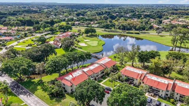 an aerial view of residential houses with outdoor space and swimming pool
