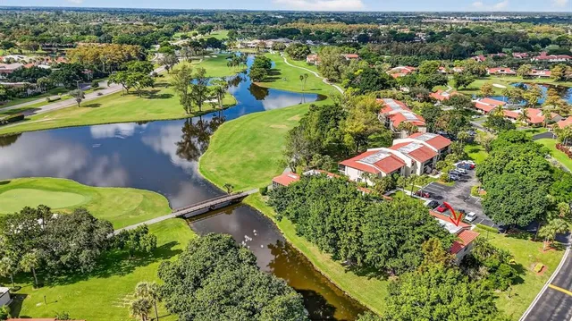 an aerial view of residential houses with outdoor space and swimming pool