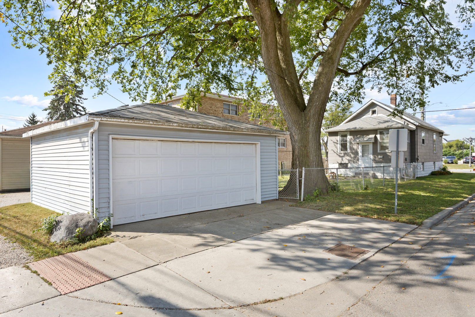 4601 Eberly Avenue Brookfield, IL 60513 - Photo 21 of 22 a front view of a house with a garden and trees