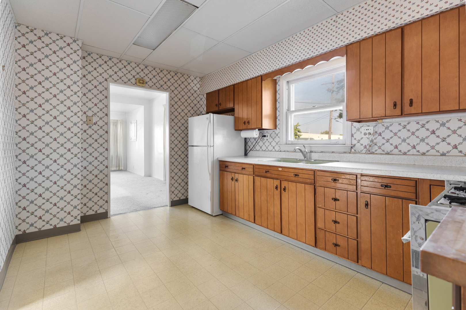 4601 Eberly Avenue Brookfield, IL 60513 - Photo 8 of 22 a kitchen with granite countertop a sink a stove a refrigerator and cabinets