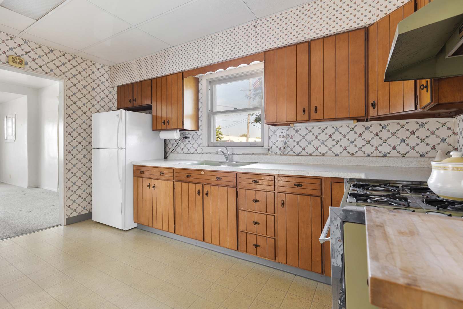4601 Eberly Avenue Brookfield, IL 60513 - Photo 9 of 22 a kitchen with granite countertop a sink cabinets stainless steel appliances and a window