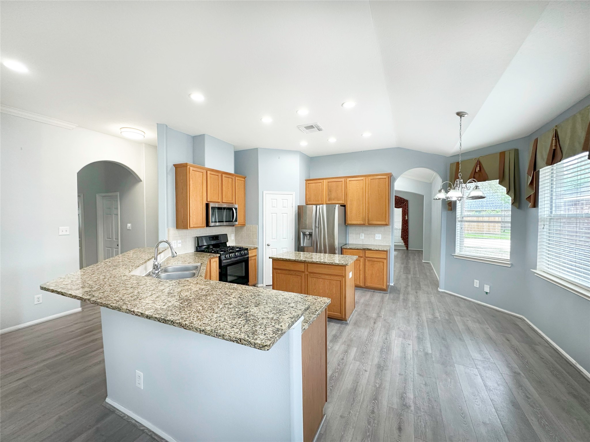 2910 Lemmingham Drive Spring, TX 77388 - Photo 11 of 31 a kitchen with stainless steel appliances granite countertop wooden cabinets and a granite counter tops