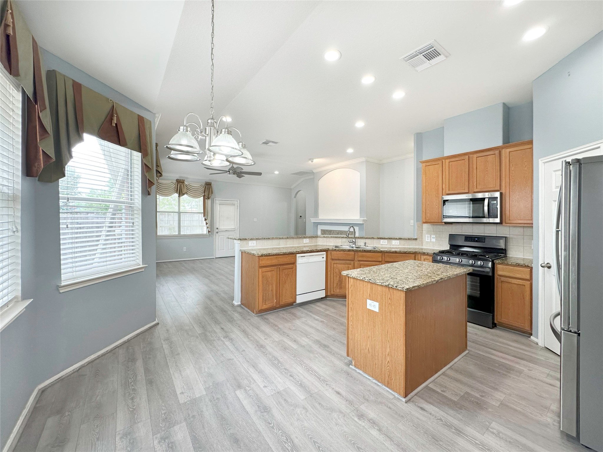 2910 Lemmingham Drive Spring, TX 77388 - Photo 13 of 31 a large kitchen with stainless steel appliances granite countertop a stove a sink dishwasher a refrigerator and a dining table with wooden floor