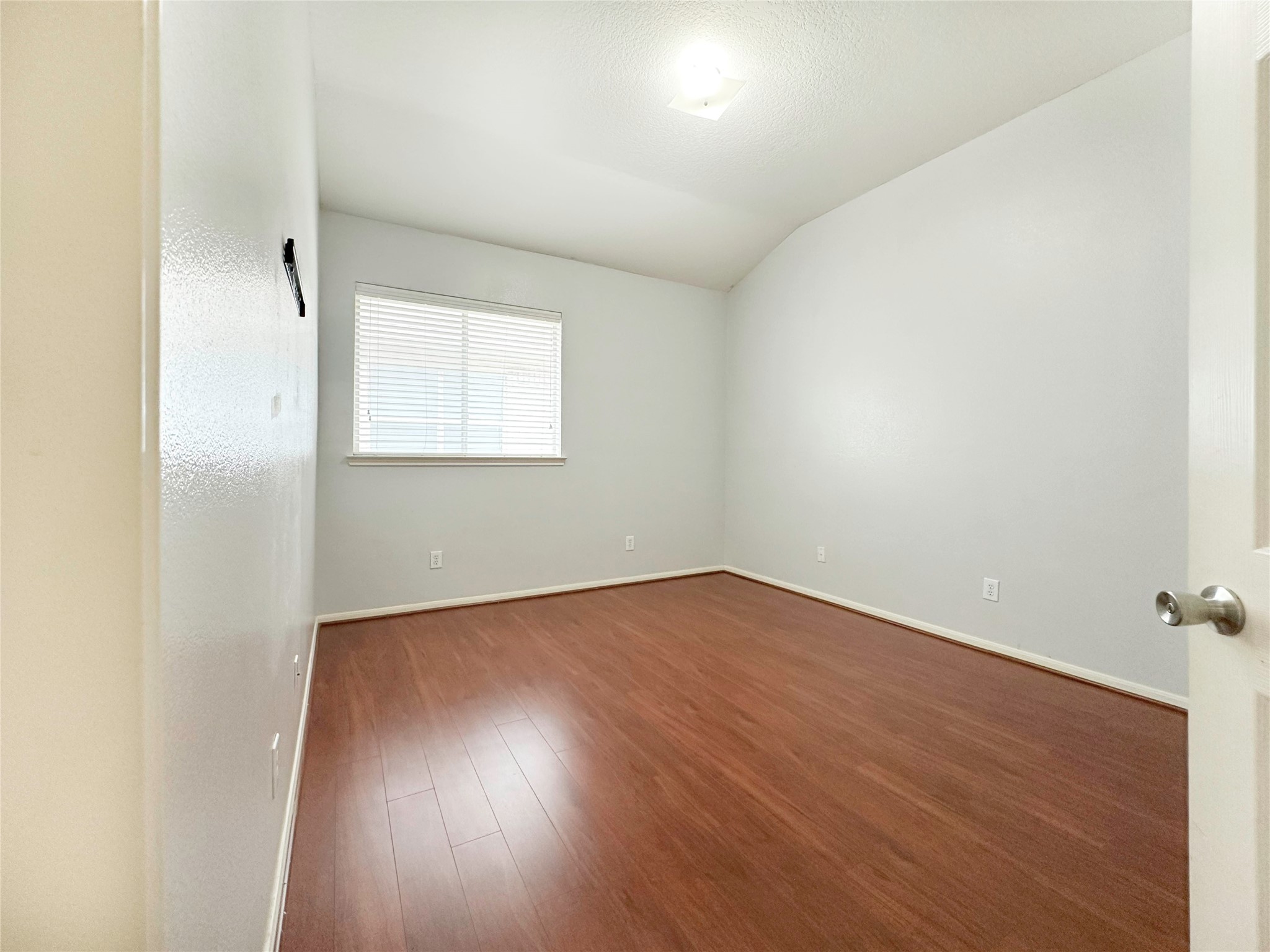 2910 Lemmingham Drive Spring, TX 77388 - Photo 14 of 31 an empty room with wooden floor and windows