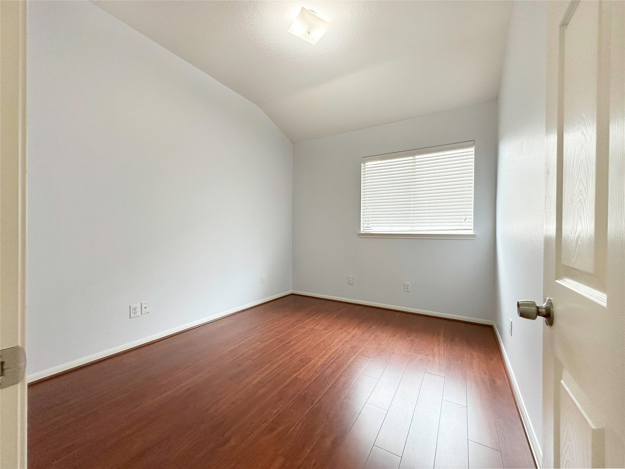2910 Lemmingham Drive Spring, TX 77388 - Photo 19 of 31 an empty room with wooden floor and windows