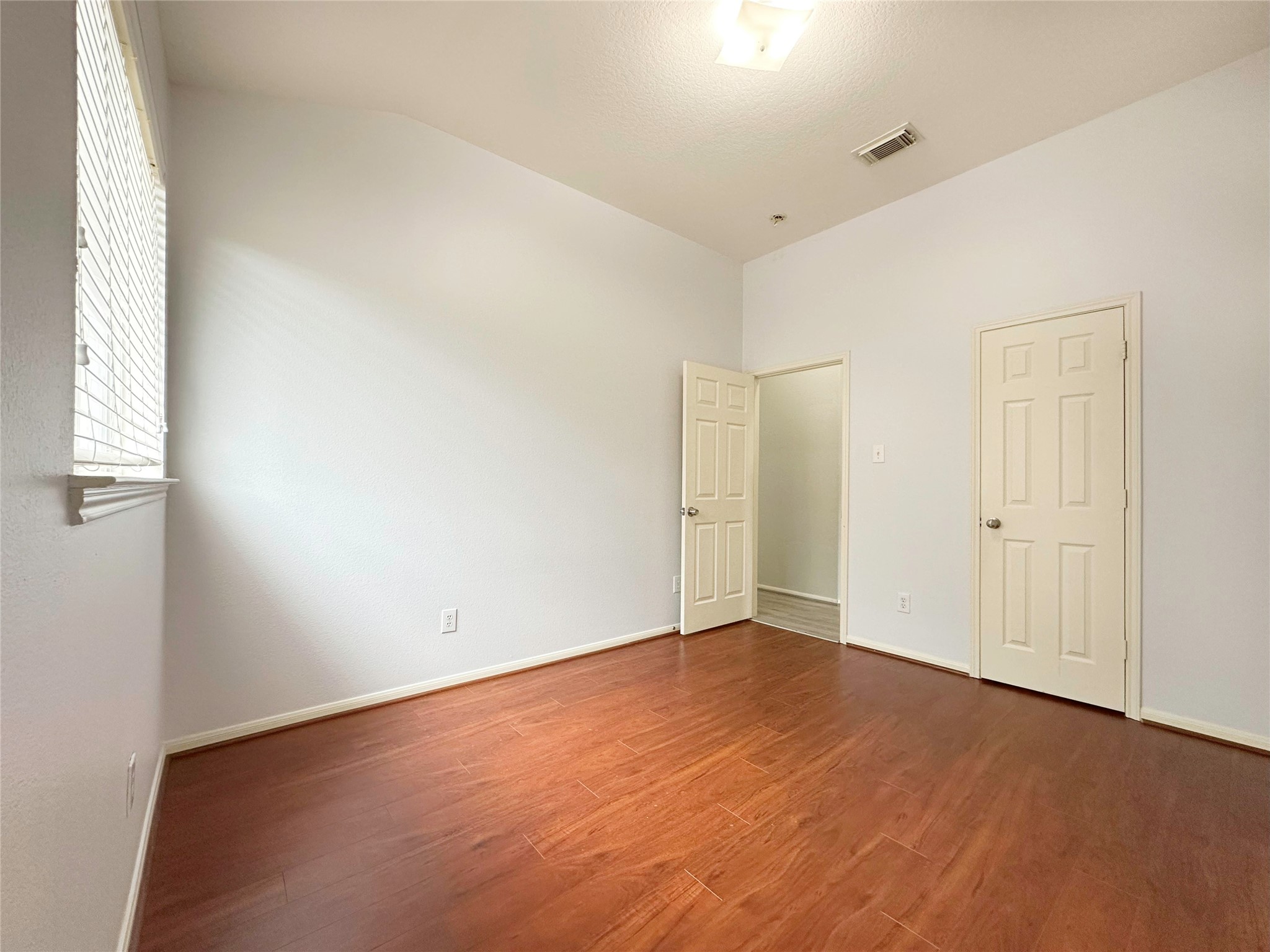 2910 Lemmingham Drive Spring, TX 77388 - Photo 20 of 31 an empty room with wooden floor and windows