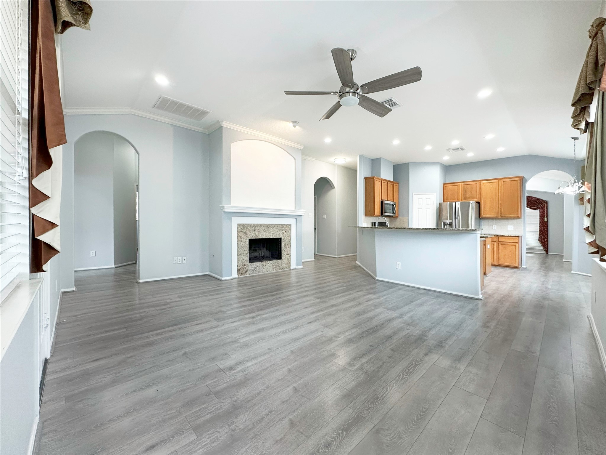 2910 Lemmingham Drive Spring, TX 77388 - Photo 9 of 31 a view of a livingroom with a fireplace a ceiling fan and wooden floor