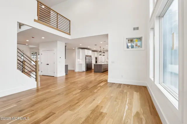 a kitchen with kitchen island granite countertop a sink cabinets and wooden floor