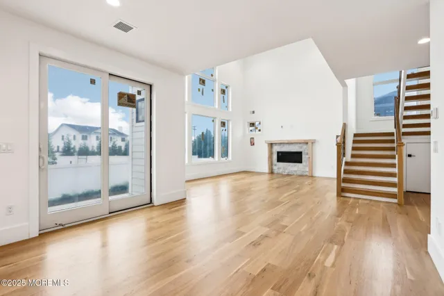 a large kitchen with stainless steel appliances kitchen island a large counter top and a wooden floors